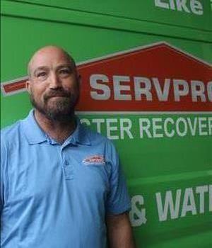 A SERVPRO employee is shown in a blue shirt with SERVPRO logo