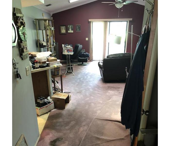 A living room with items damaged from a flood