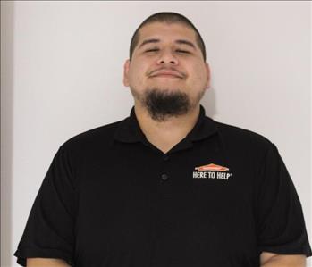 A SERVPRO employee is shown in a black shirt with SERVPRO logo