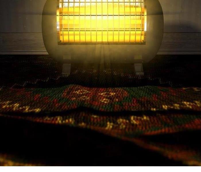 A space heater is shown near a rug 